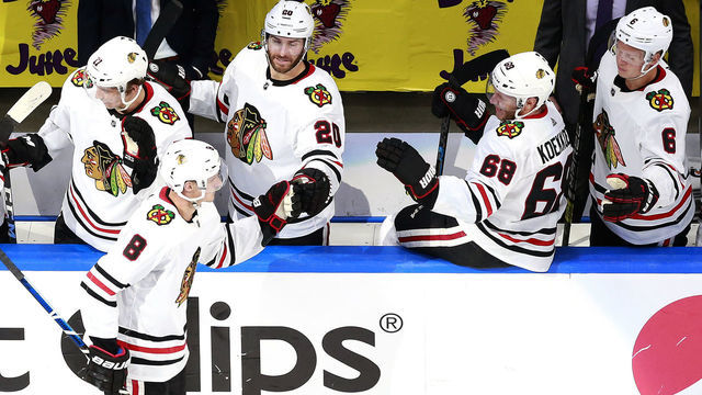 EDMONTON, ALBERTA - AUGUST 01: Dominik Kubalik #8 of the Chicago Blackhawks is congratulated by teammates on the bench after he scored in the second period against the Edmonton Oilers in Game One of the Eastern Conference Qualification Round prior to the 2020 NHL Stanley Cup Playoffs at Rogers Place on August 01, 2020 in Edmonton, Alberta.