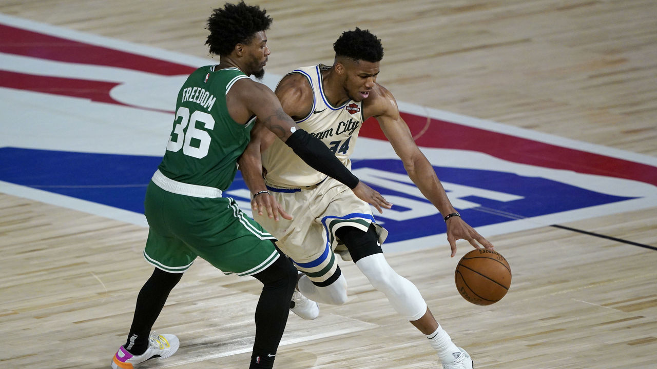 LAKE BUENA VISTA, FL - JULY 31: Giannis Antetokounmpo #34 of the Milwaukee Bucks, right, drives around Marcus Smart #36 of the Boston Celtics during the second half of an NBA basketball game Friday, July 31, 2020, in Lake Buena Vista, Florida.