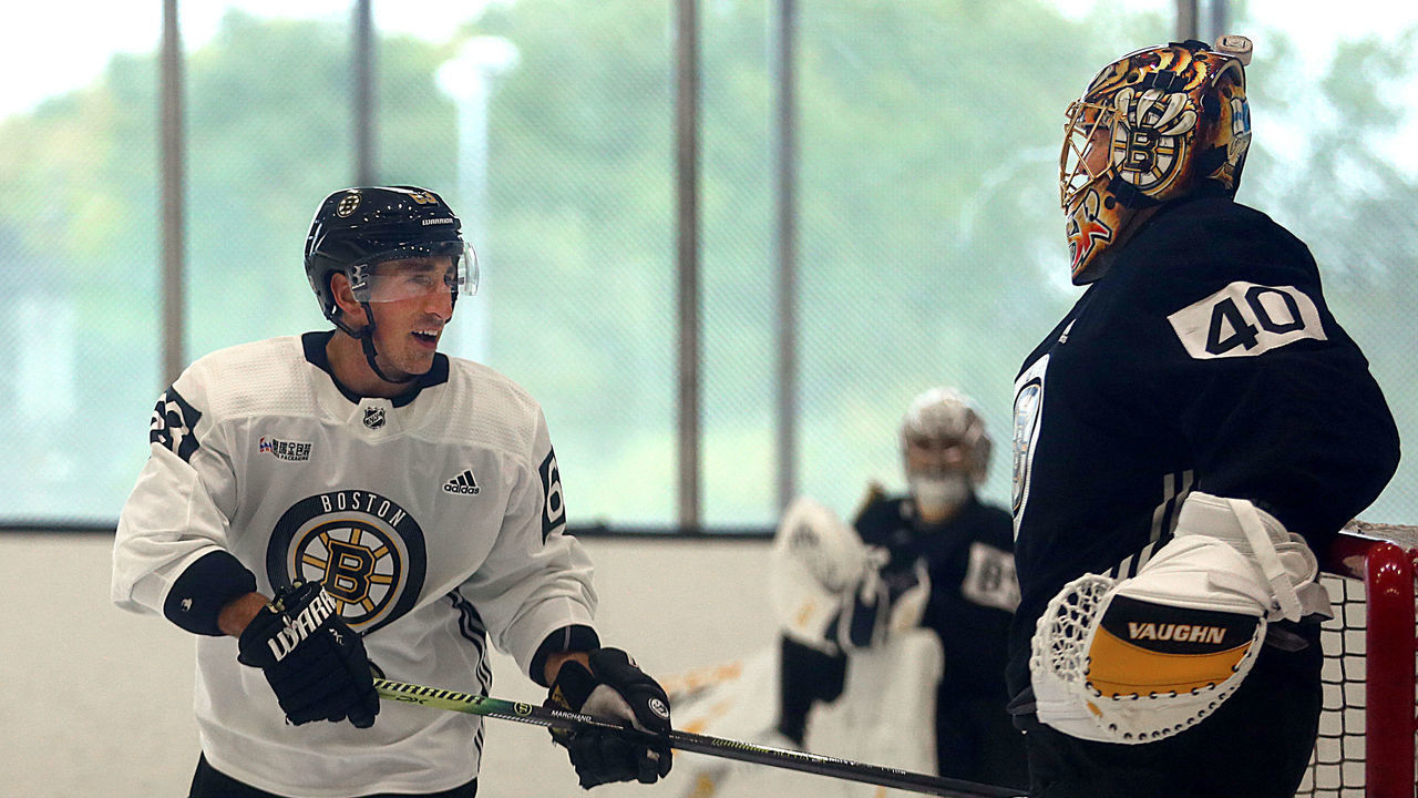 BOSTON - SEPTEMBER 14: Boston Bruins' Brad Marchand shares a laugh with goalie Tuukka Rask after he took a close shot on him during a drill at practice at the Warrior Ice Arena in the Brighton neighborhood of Boston on Sep. 14, 2019.