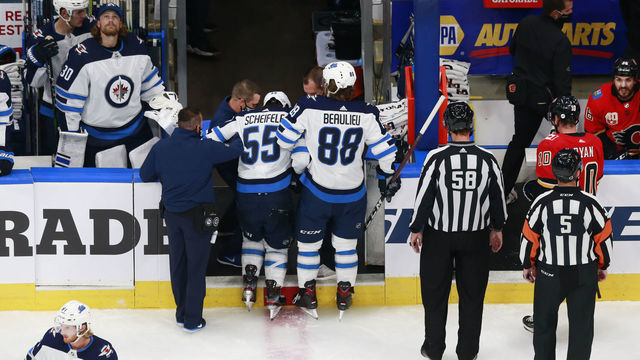 EDMONTON, ALBERTA - AUGUST 01: Mark Scheifele #55 of the Winnipeg Jets is helped off of the ice by Nathan Beaulieu #88 of the Winnipeg Jets after a hard hit against the Calgary Flames in Game One of the Western Conference Qualification Round prior to the 2020 NHL Stanley Cup Playoffs at Rogers Place on August 01, 2020 in Edmonton, Alberta.