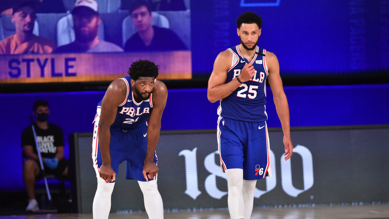 Orlando, FL - AUGUST 1: Joel Embiid #21 of the Philadelphia 76ers and Ben Simmons #25 of the Philadelphia 76ers look on during a game against the Indiana Pacers on August 1, 2020 at Visa Athletic Center at ESPN Wide World of Sports in Orlando, Florida. NOTE TO USER: User expressly acknowledges and agrees that, by downloading and/or using this Photograph, user is consenting to the terms and conditions of the Getty Images License Agreement. Mandatory Copyright Notice: Copyright 2020 NBAE