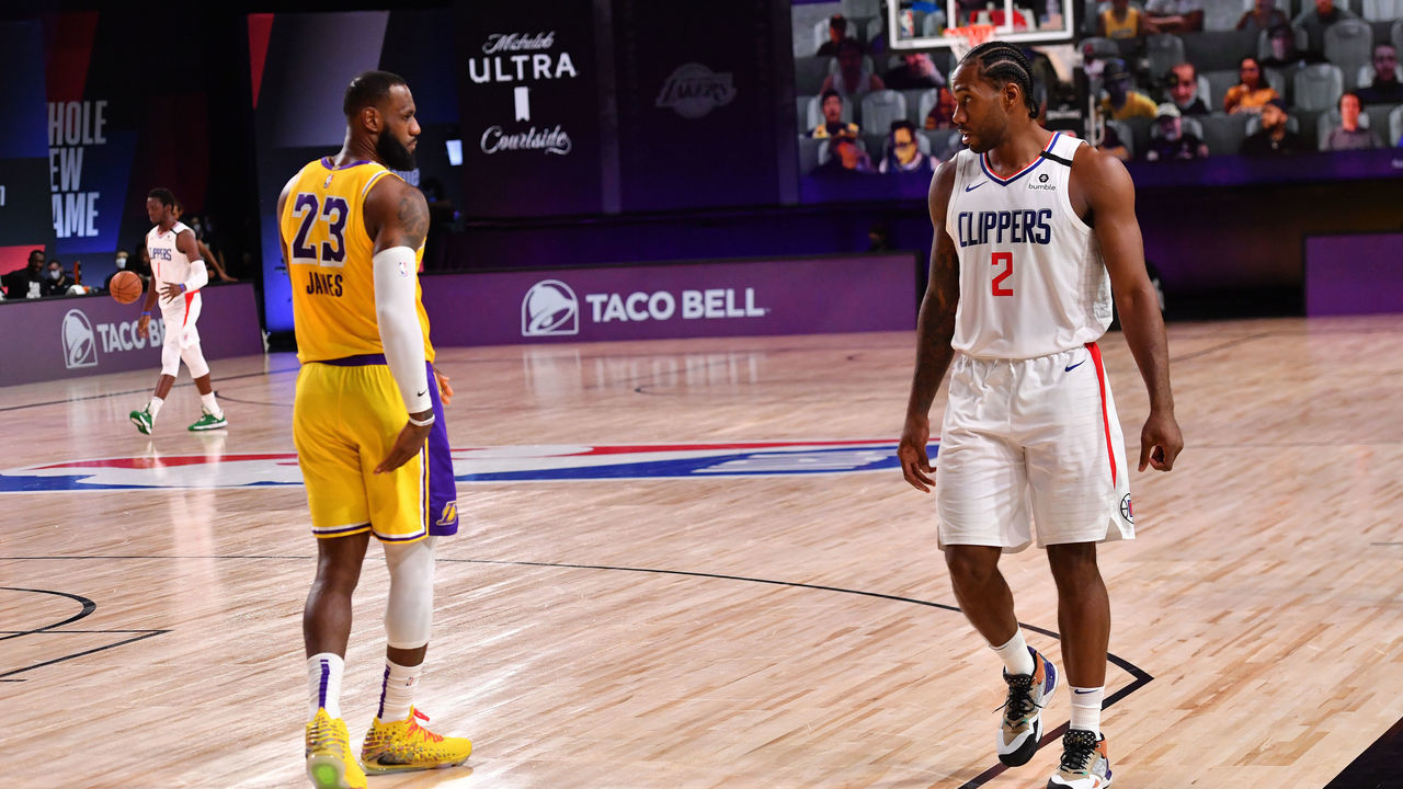 Orlando, FL - JULY 30: LeBron James #23 of the Los Angeles Lakers and Kawhi Leonard #2 of the LA Clippers look on during a game on July 30, 2020 at The Arena at ESPN Wide World Of Sports Complex in Orlando, Florida. NOTE TO USER: User expressly acknowledges and agrees that, by downloading and/or using this Photograph, user is consenting to the terms and conditions of the Getty Images License Agreement. Mandatory Copyright Notice: Copyright 2020 NBAE