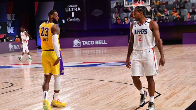 Orlando, FL - JULY 30: LeBron James #23 of the Los Angeles Lakers and Kawhi Leonard #2 of the LA Clippers look on during a game on July 30, 2020 at The Arena at ESPN Wide World Of Sports Complex in Orlando, Florida. NOTE TO USER: User expressly acknowledges and agrees that, by downloading and/or using this Photograph, user is consenting to the terms and conditions of the Getty Images License Agreement. Mandatory Copyright Notice: Copyright 2020 NBAE