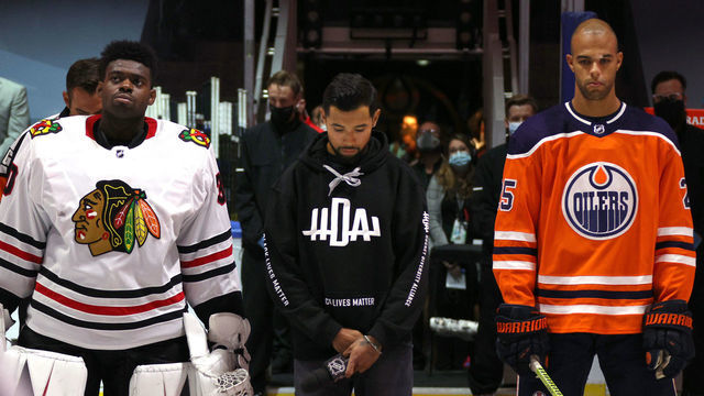 EDMONTON, ALBERTA - AUGUST 01: (L-R) Malcolm Subban #30 of the Chicago Blackhawks, Mathew Dumba of the Minnesota Wild and Darnell Nurse #25 of the Edmonton Oilers during the national anthem of the Canada before Game One of the Western Conference Qualification Round between the Edmonton Oilers and the Chicago Blackhawks at Rogers Place on August 01, 2020 in Edmonton, Alberta.