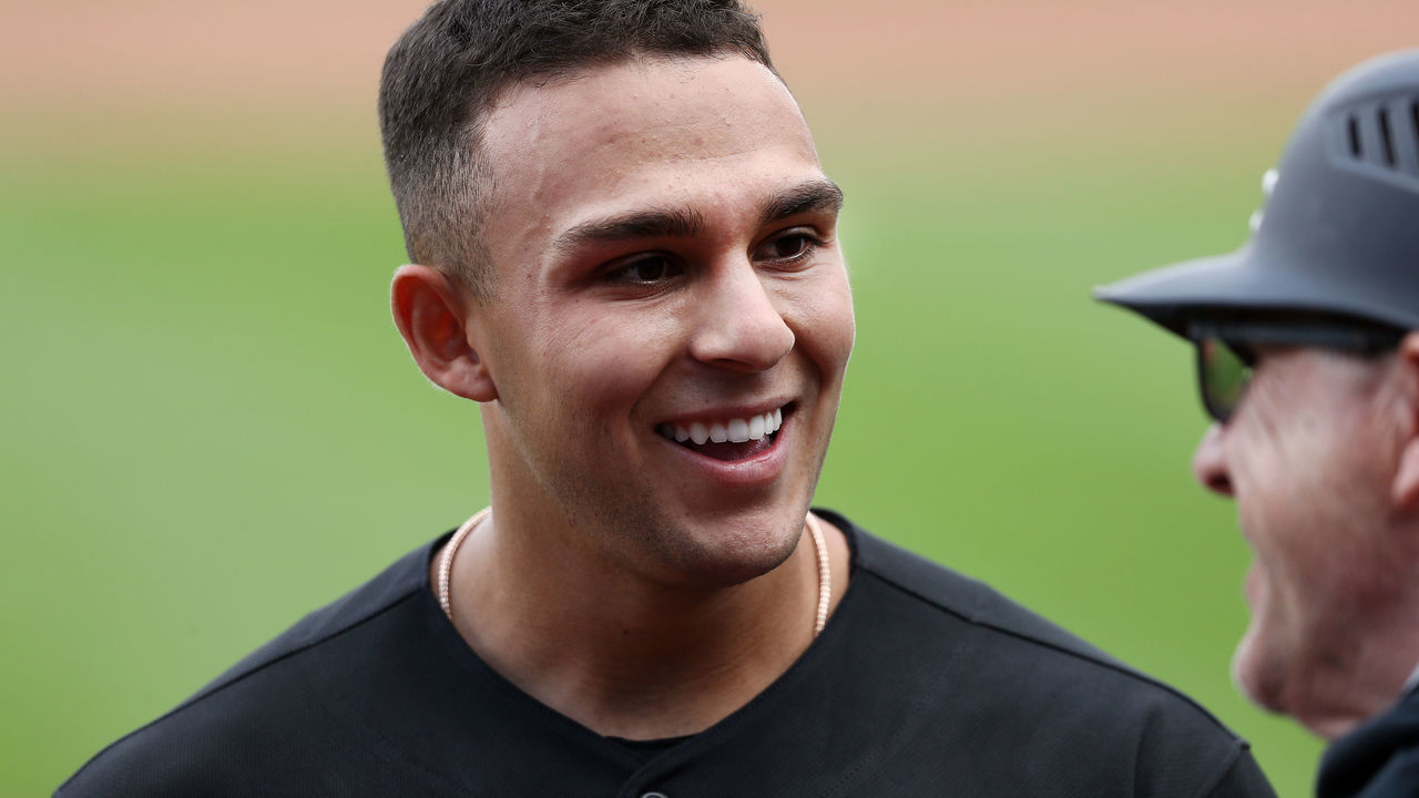 KANSAS CITY, MISSOURI - AUGUST 02: Nick Madrigal #1 of the Chicago White Sox jokes with third base coach Nick Capra after recording his first Major League hit during the 3rd inning of the game against the Kansas City Royals at Kauffman Stadium on August 02, 2020 in Kansas City, Missouri.