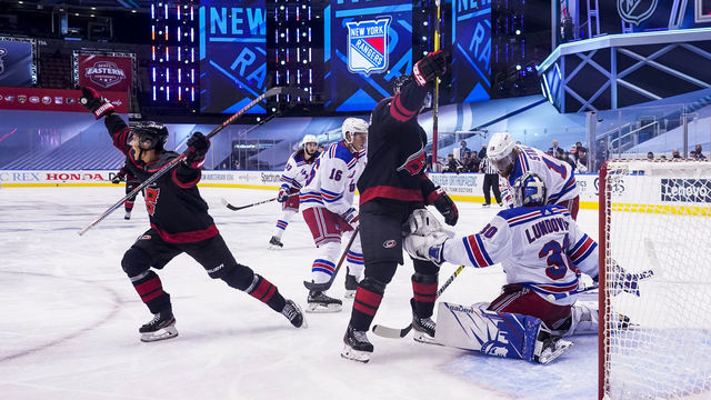 TORONTO, ONTARIO - AUGUST 01: Sebastian Aho #20 of the Carolina Hurricanes, left, celebrates after scoring against Henrik Lundqvist #30 of the New York Rangers during the second period in Game One of the Eastern Conference Qualification Round at Scotiabank Arena on August 01, 2020 in Toronto, Ontario.