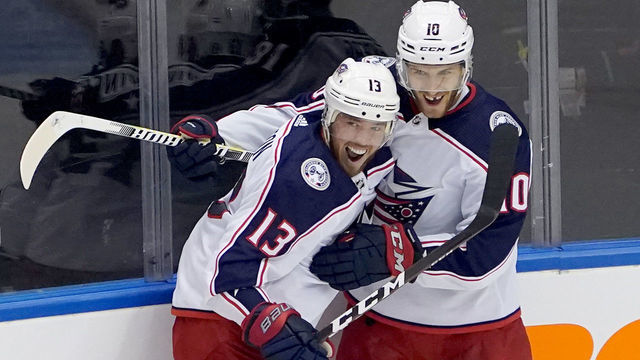 TORONTO, ONTARIO - AUGUST 02: Cam Atkinson #13 of the Columbus Blue Jackets is congratulated by teammate Alexander Wennberg #10 after he scored a goal in the third period against the Toronto Maple Leafs in Game One of the Eastern Conference Qualification Round prior to the 2020 NHL Stanley Cup Playoffs at Scotiabank Arena on August 02, 2020 in Toronto, Ontario, Canada.