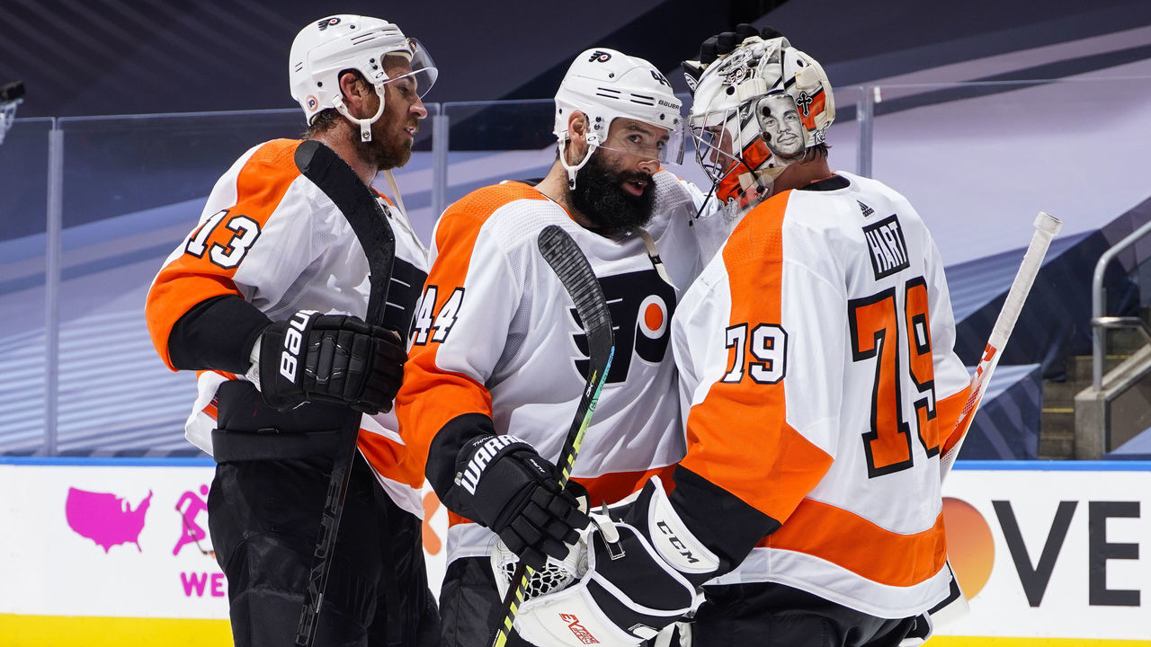TORONTO, ONTARIO - AUGUST 02: Kevin Hayes #13, Nate Thompson #44 and Carter Hart #79 of the Philadelphia Flyers celebrate after defeating the Boston Bruins in a Round Robin game during the 2020 NHL Stanley Cup Playoff at Scotiabank Arena on August 02, 2020 in Toronto, Ontario.