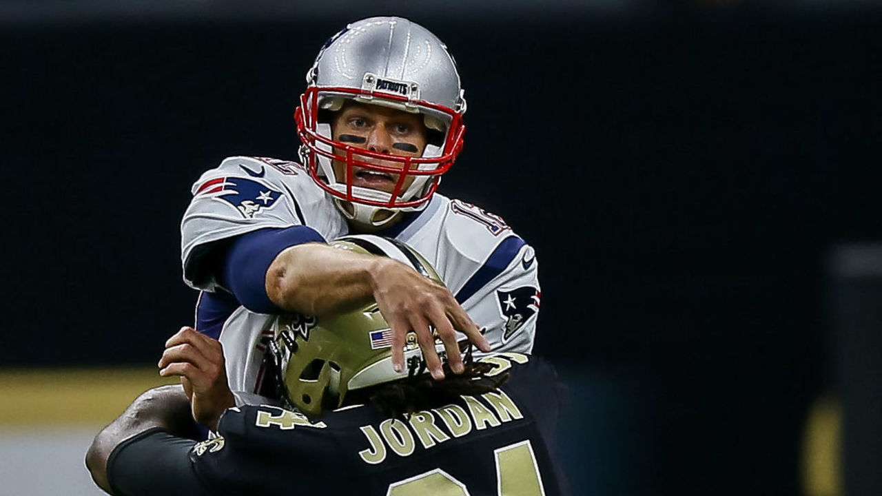 NEW ORLEANS, LA. - SEPTEMBER 17: New England Patriots quarterback Tom Brady (12) gets the ball off before being hit by New Orleans Saints defensive end Cameron Jordan (94) during the game between between the New England Patriots and the New Orleans Saints on September 17, 2017 at the Mercedes-Benz Superdome in New Orleans, LA. New England Patriots won 36-20.