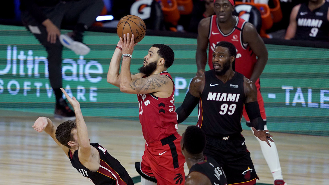 LAKE BUENA VISTA, FLORIDA - AUGUST 03: Fred VanVleet #23 of the Toronto Raptors shoots as Goran Dragic #7 of the Miami Heat tries to draw the offensive foul in the second half at HP Field House at ESPN Wide World Of Sports Complex on August 3, 2020 in Lake Buena Vista, Florida.