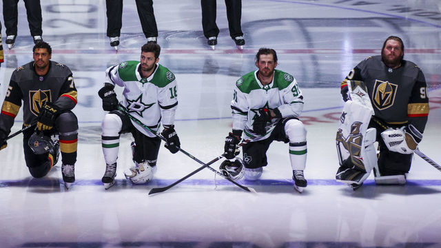 EDMONTON, ALBERTA - AUGUST 03: Ryan Reaves #75 and Robin Lehner #90 of the Vegas Golden Knights kneel during the singing of the American national anthem alongside Jason Dickinson #18 and Tyler Seguin #91 of the Dallas Stars before the start of the Round Robin game during the 2020 NHL Stanley Cup Playoff at Rogers Place on August 03, 2020 in Edmonton, Alberta.