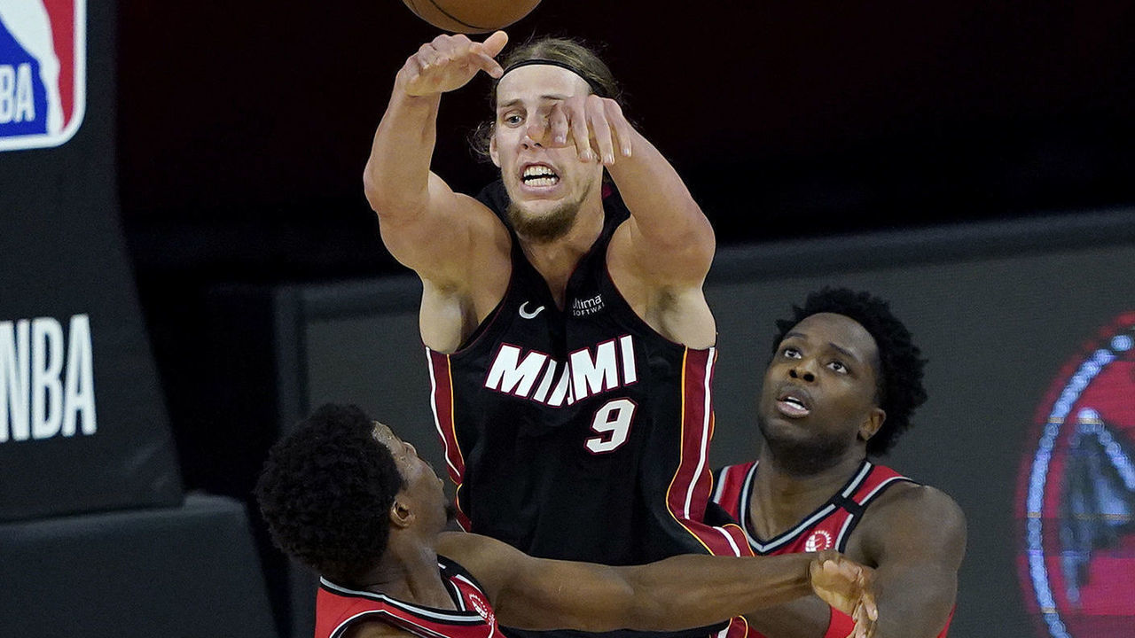 LAKE BUENA VISTA, FLORIDA - AUGUST 03: Kelly Olynyk #9 of the Miami Heat passes over OG Anunoby #3 and Kyle Lowry #7 of the Toronto Raptors during a game at HP Field House at ESPN Wide World Of Sports Complex on August 3, 2020 in Lake Buena Vista, Florida.