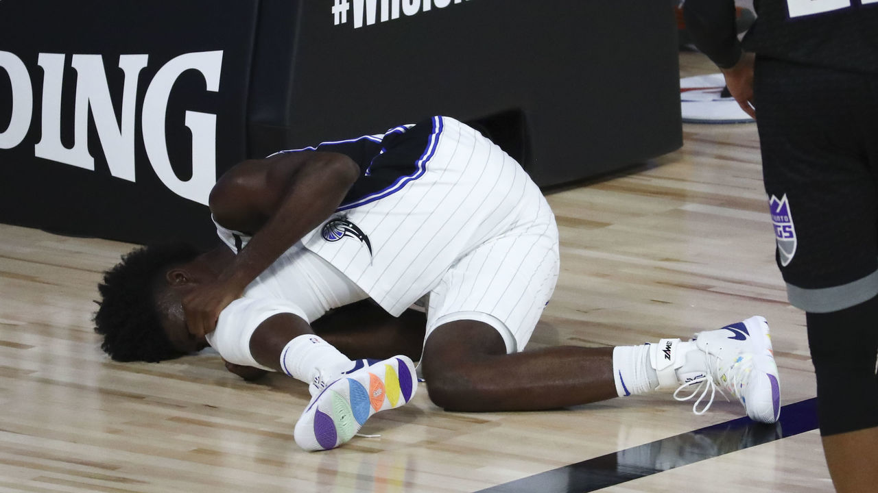 LAKE BUENA VISTA, FLORIDA - AUGUST 02: Jonathan Isaac #1 of the Orlando Magic reacts after an injury against the Sacramento Kings in the second half of a NBA basketball game at HP Field House at ESPN Wide World Of Sports Complex on August 2, 2020 in Lake Buena Vista, Florida.