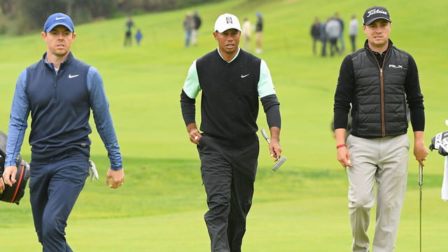 PACIFIC PALISADES, CALIFORNIA - FEBRUARY 15: Rory McIlroy of Northern Ireland, Tiger Woods and Justin Thomas walk up the 18th hole green during the continuation of the first round of the Genesis Open at Riviera Country Club on February 15, 2019 in Pacific Palisades, California