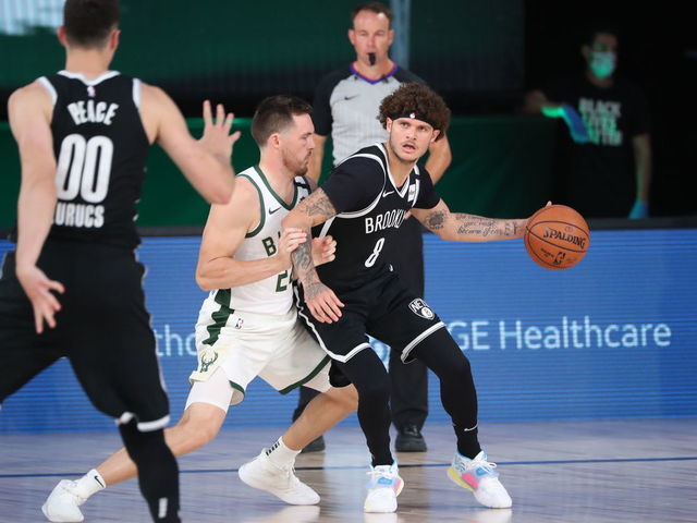 Orlando, FL - AUGUST 4: Tyler Johnson #8 of the Brooklyn Nets handles the ball during the game against the Milwaukee Bucks on August 4, 2020 at The Visa Athletic Center at ESPN Wide World Of Sports Complex in Reunion, Florida. NOTE TO USER: User expressly acknowledges and agrees that, by downloading and/or using this Photograph, user is consenting to the terms and conditions of the Getty Images License Agreement. Mandatory Copyright Notice: Copyright 2020 NBAE
