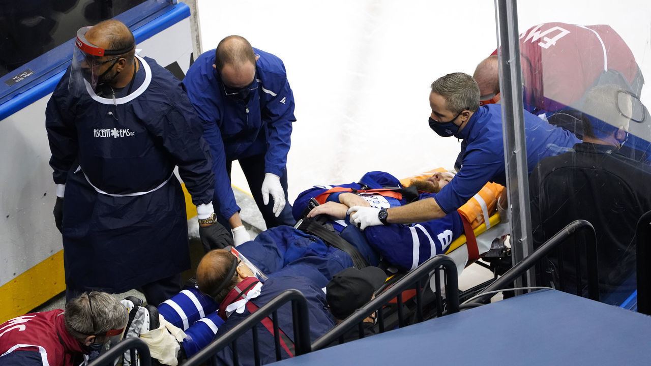 TORONTO, ONTARIO - AUGUST 04: Jake Muzzin #8 of the Toronto Maple Leafs is carried off the ice during the third period in Game Two of the Eastern Conference Qualification Round prior to the 2020 NHL Stanley Cup Playoff at Scotiabank Arena on August 04, 2020 in Toronto, Ontario, Canada.
