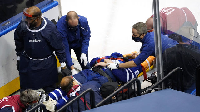 TORONTO, ONTARIO - AUGUST 04: Jake Muzzin #8 of the Toronto Maple Leafs is carried off the ice during the third period in Game Two of the Eastern Conference Qualification Round prior to the 2020 NHL Stanley Cup Playoff at Scotiabank Arena on August 04, 2020 in Toronto, Ontario, Canada.