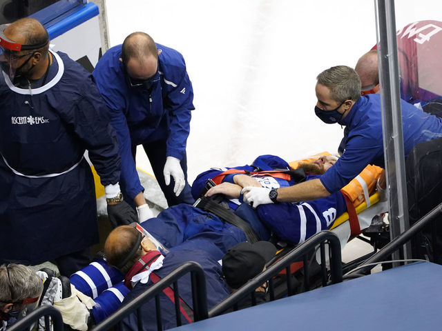 TORONTO, ONTARIO - AUGUST 04: Jake Muzzin #8 of the Toronto Maple Leafs is carried off the ice during the third period in Game Two of the Eastern Conference Qualification Round prior to the 2020 NHL Stanley Cup Playoff at Scotiabank Arena on August 04, 2020 in Toronto, Ontario, Canada.