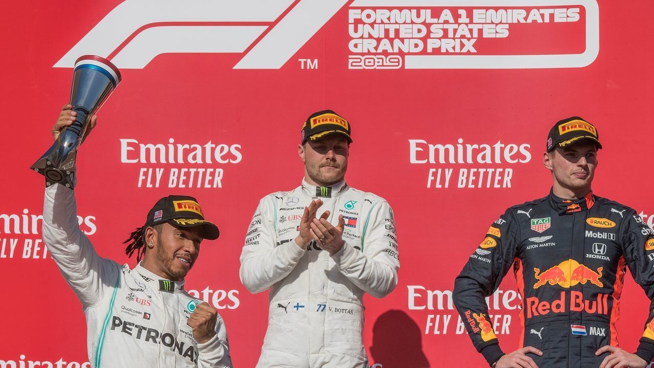 Lewis Hamilton of Great Britain driving the (44) Mercedes AMG Petronas F1 Team (L) reacts after being crowned World Champion during his second place finish, beside winner Valtteri Bottas of the Mercedes AMG Petronas F1 Team (C) and third place Max Verstappen of the Netherlands driving the (33) Aston Martin Red Bull Racing (R) at the F1 Grand Prix of USA at Circuit of The Americas in Austin, Texas on November 03, 2019. - Lewis Hamilton claimed his sixth drivers world championship title on Sunday when he finished second at the United States Grand Prix.