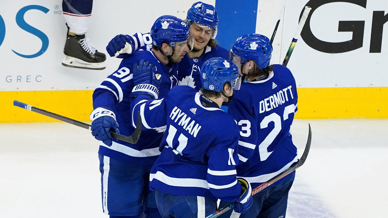 TORONTO, ONTARIO - AUGUST 04: John Tavares #91 of the Toronto Maple Leafs is congratulated by his teammates after scoring a goal against the Columbus Blue Jackets during the third period in Game Two of the Eastern Conference Qualification Round prior to the 2020 NHL Stanley Cup Playoff at Scotiabank Arena on August 04, 2020 in Toronto, Ontario, Canada.