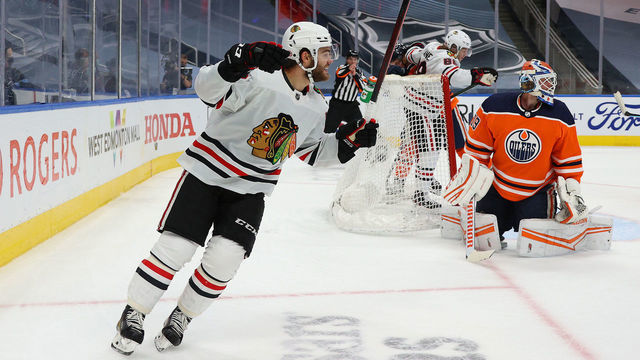 EDMONTON, ALBERTA - AUGUST 03: Alex DeBrincat #12 of the Chicago Blackhawks reacts in the second period of Game Two of the Western Conference Qualification Round prior to the 2020 NHL Stanley Cup Playoffs at Rogers Place on August 03, 2020 in Edmonton, Alberta.