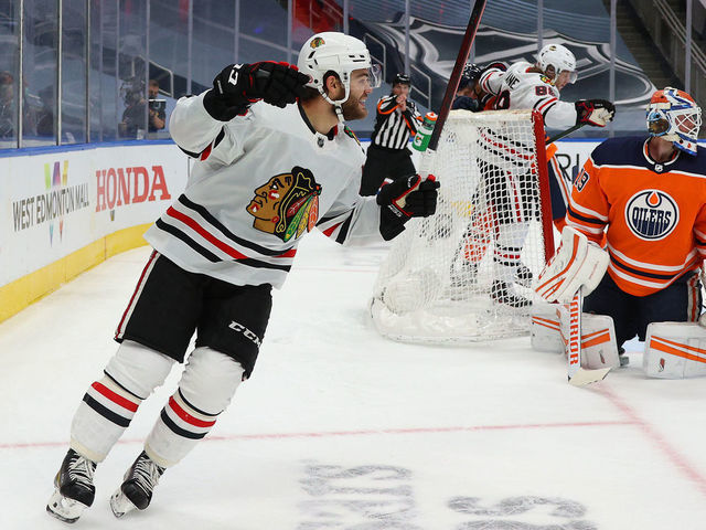 EDMONTON, ALBERTA - AUGUST 03: Alex DeBrincat #12 of the Chicago Blackhawks reacts in the second period of Game Two of the Western Conference Qualification Round prior to the 2020 NHL Stanley Cup Playoffs at Rogers Place on August 03, 2020 in Edmonton, Alberta.