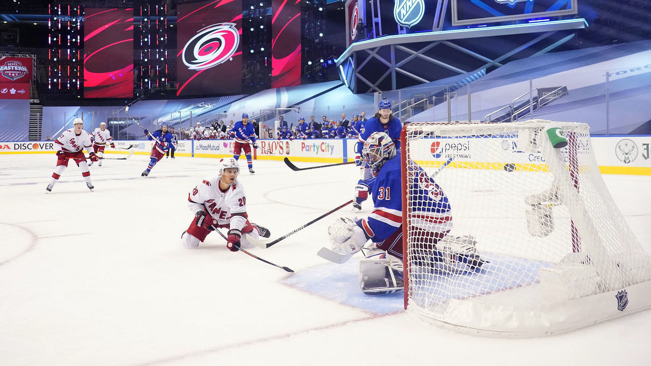 TORONTO, ONTARIO - AUGUST 04: Sebastian Aho #20 of the Carolina Hurricanes scores against goaltender Igor Shesterkin #31 of the New York Rangers in the third period of Game Three of the Eastern Conference Qualification Round prior to the 2020 NHL Stanley Cup Playoffs at Scotiabank Arena on August 04, 2020 in Toronto, Ontario.