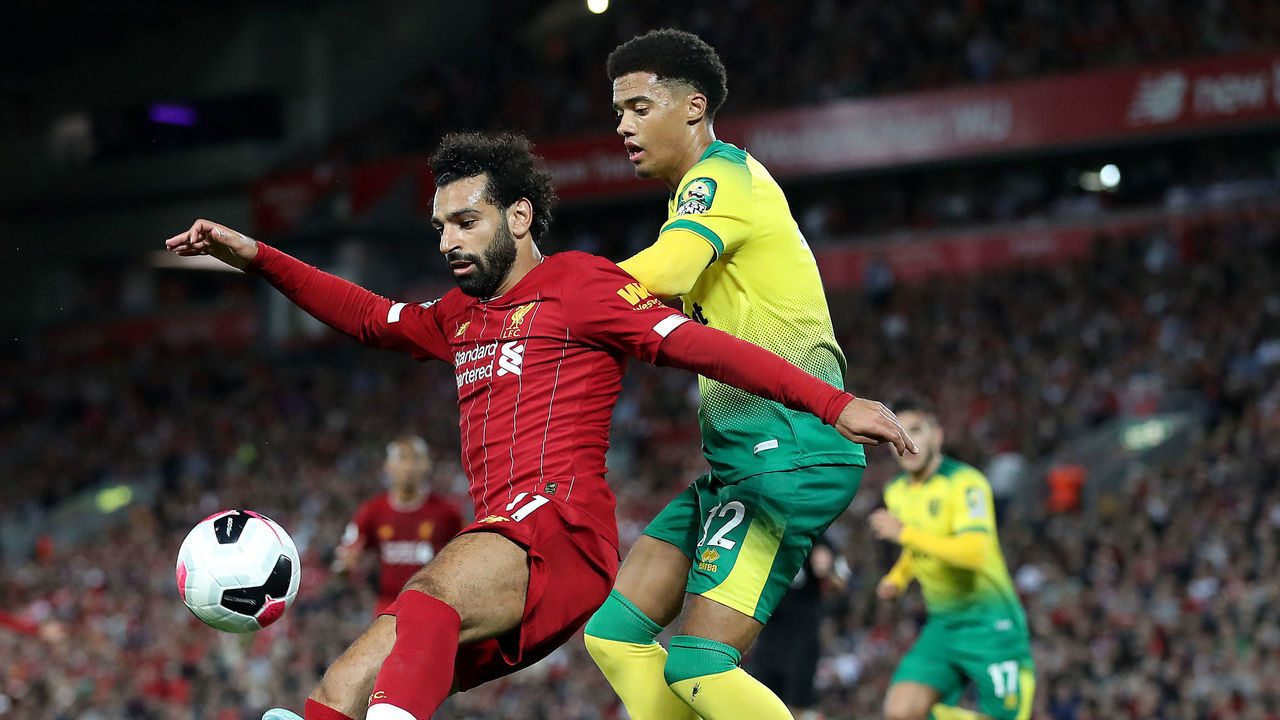 Liverpool's Mohamed Salah (left) and Norwich City's Jamal Lewis battle for the ball during the Premier League match at Anfield, Liverpool.
