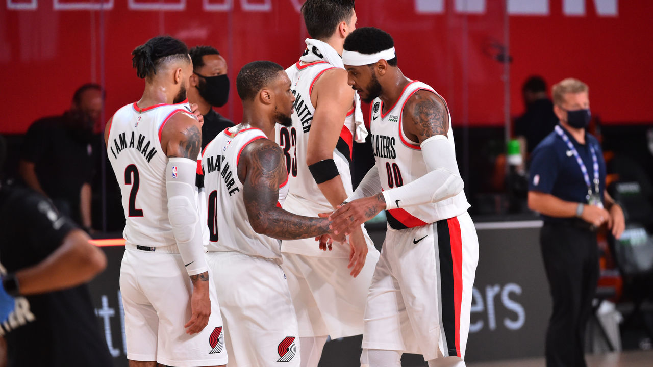 Orlando, FL - JULY 31: Damian Lillard #0 of the Portland Trail Blazers and Carmelo Anthony #00 of the Portland Trail Blazers high-five after a game against the Memphis Grizzlies on July 31, 2020 at The Arena at ESPN Wide World Of Sports Complex in Orlando, Florida. NOTE TO USER: User expressly acknowledges and agrees that, by downloading and/or using this Photograph, user is consenting to the terms and conditions of the Getty Images License Agreement. Mandatory Copyright Notice: Copyright 2020 NBAE