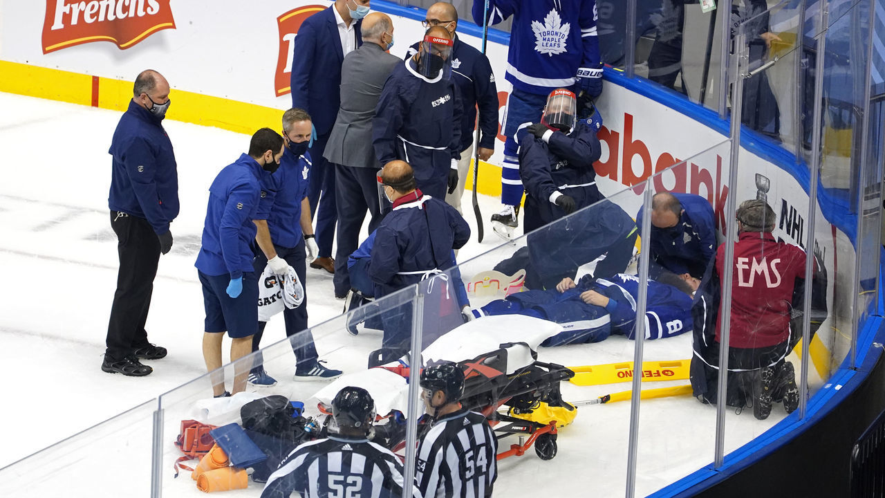 TORONTO, ONTARIO - AUGUST 04: Jake Muzzin #8 of the Toronto Maple Leafs is carried off the ice during the third period in Game Two of the Eastern Conference Qualification Round prior to the 2020 NHL Stanley Cup Playoff at Scotiabank Arena on August 04, 2020 in Toronto, Ontario, Canada.