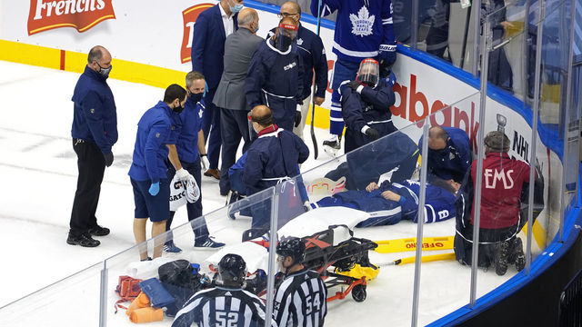 TORONTO, ONTARIO - AUGUST 04: Jake Muzzin #8 of the Toronto Maple Leafs is carried off the ice during the third period in Game Two of the Eastern Conference Qualification Round prior to the 2020 NHL Stanley Cup Playoff at Scotiabank Arena on August 04, 2020 in Toronto, Ontario, Canada.