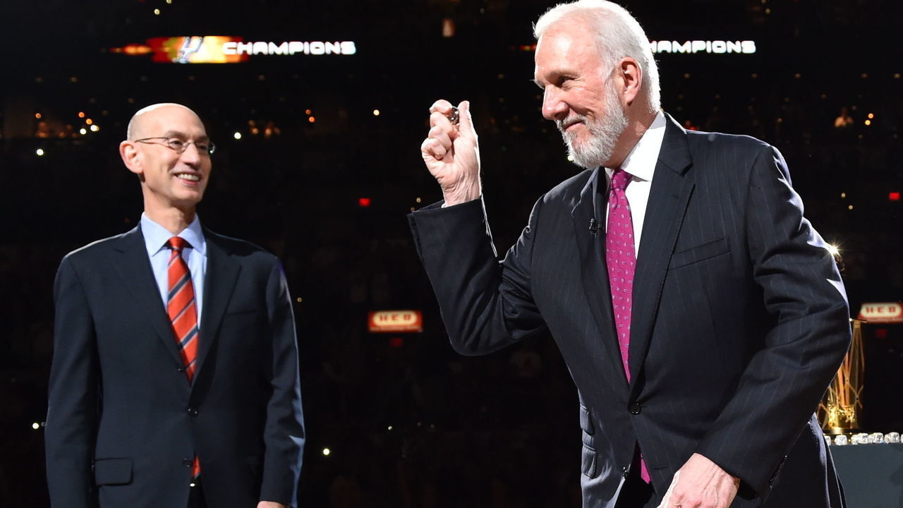 SAN ANTONIO, TX - OCTOBER 28: Spurs head coach Gregg Popovich raises his ring after receiveing it from NBA Commissioner Adam Silver and owner Peter Holt during the opening ceremony on October 28, 2014 at the AT&T Center in San Antonio,Texas. Mandatory Copyright Notice: Copyright 2014 NBAE