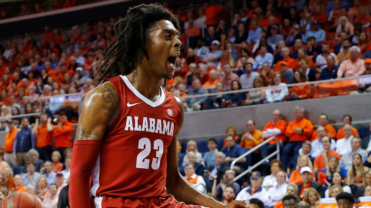 AUBURN, ALABAMA - FEBRUARY 12: John Petty Jr. #23 of the Alabama Crimson Tide dunks against Allen Flanigan #22 of the Auburn Tigers in the first half at Auburn Arena on February 12, 2020 in Auburn, Alabama.