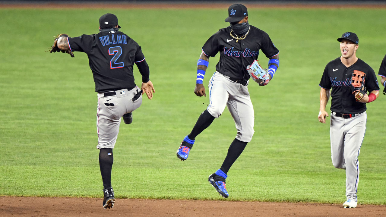 BALTIMORE, MD - AUGUST 05: Miami Marlins center fielder Monte Harrison (4) leaps in the air to celebrate with shortstop Jonathan Villar (2) following the Marlins 2-1 win against the Baltimore Orioles in the second game of a double header on August 5, 2020, at Orioles Park at Camden Yards, in Baltimore, MD.