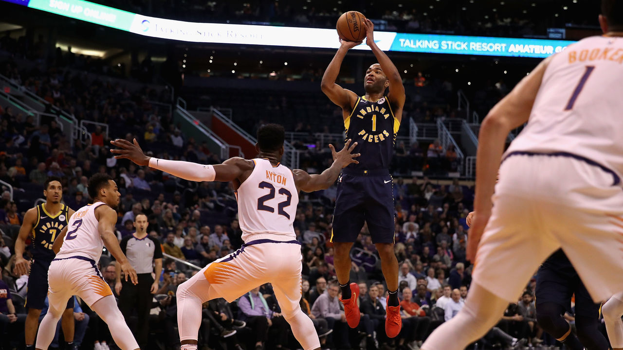 PHOENIX, ARIZONA - JANUARY 22: T.J. Warren #1 of the Indiana Pacers attempts a shot over Deandre Ayton #22 of the Phoenix Suns during the first half of the NBA game at Talking Stick Resort Arena on January 22, 2020 in Phoenix, Arizona.