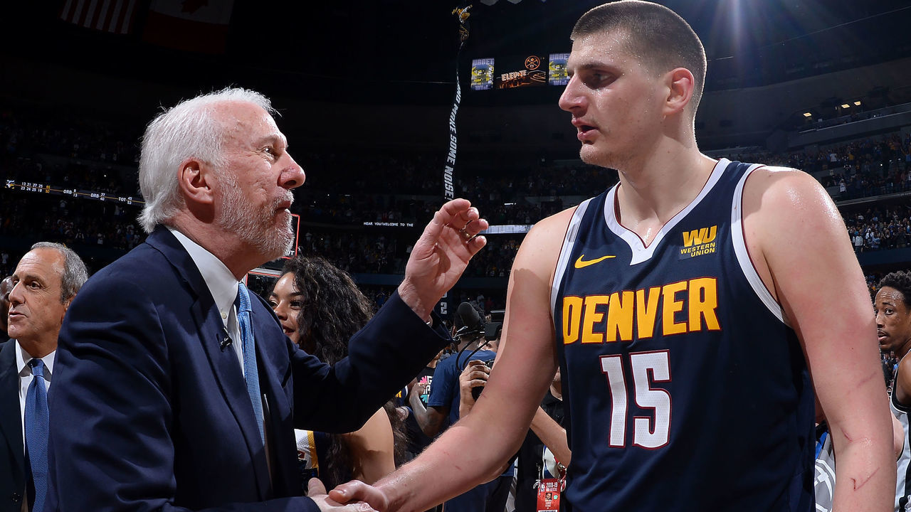 DENVER, CO - APRIL 27: Head Coach Gregg Popovich of the San Antonio Spurs talks with Nikola Jokic #15 of the Denver Nuggets after Game Seven of Round One of the 2019 NBA Playoffs on April 27, 2019 at the Pepsi Center in Denver, Colorado. NOTE TO USER: User expressly acknowledges and agrees that, by downloading and/or using this Photograph, user is consenting to the terms and conditions of the Getty Images License Agreement. Mandatory Copyright Notice: Copyright 2019 NBAE