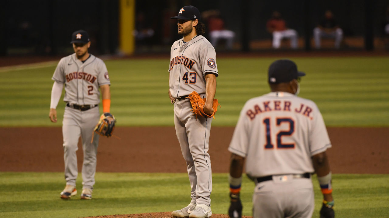 PHOENIX, ARIZONA - AUGUST 05: Lance McCullers Jr. #43 of the Houston Astros looks in at home plate as manager Dusty Baker Jr #12 walks out to make a pitching change during the fourth inning against the Arizona Diamondbacks at Chase Field on August 05, 2020 in Phoenix, Arizona.