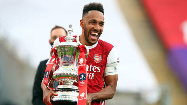 LONDON, ENGLAND - AUGUST 01: Pierre-Emerick Aubameyang of Arsenal celebrates with the trophy during the FA Cup Final match between Arsenal and Chelsea at Wembley Stadium on August 1, 2020 in London, England. Football Stadiums around Europe remain empty due to the Coronavirus Pandemic as Government social distancing laws prohibit fans inside venues resulting in all fixtures being played behind closed doors.