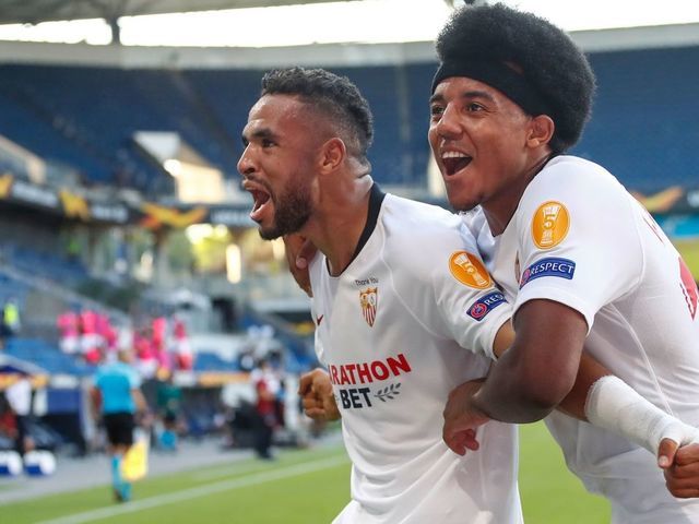 Sevilla's Moroccan forward Youssef En-Nesyri (L) celebrates scoring with Sevilla's French defender Jules Kounde during the UEFA Europa League round of 16 football match between Sevilla FC and AS Roma at the MSV Arena on August 6, 2020 in Duisburg.