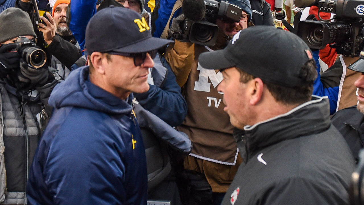 ANN ARBOR, MICHIGAN - NOVEMBER 30: Head Coach Ryan Day (R) of the Ohio State Buckeyes shakes hands with Head Coach Jim Harbaugh (L) of the Michigan Wolverines after a college football game at Michigan Stadium on November 30, 2019 in Ann Arbor, MI. The Ohio State Buckeyes won the game 56-27 over the Michigan Wolverines.