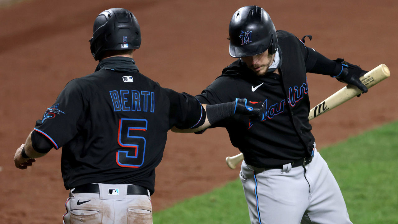 BALTIMORE, MARYLAND - AUGUST 06: Jon Berti #5 of the Miami Marlins celebrates scoring a run with Brian Anderson #15 against the Baltimore Orioles in the seventh inning at Oriole Park at Camden Yards on August 06, 2020 in Baltimore, Maryland.