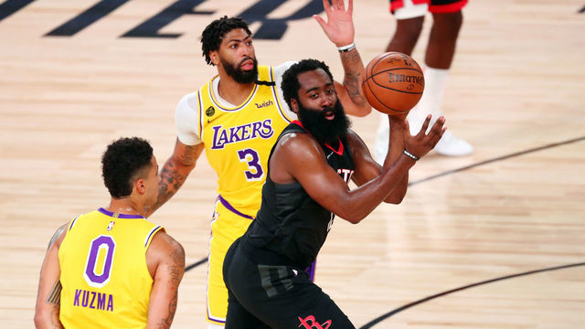 LAKE BUENA VISTA, FLORIDA - AUGUST 06: James Harden #13 of the Houston Rockets passes the ball against Kyle Kuzma #0 and Anthony Davis #3 of the Los Angeles Lakers in the second half at The Arena at ESPN Wide World Of Sports Complex on August 6, 2020 in Lake Buena Vista, Florida.