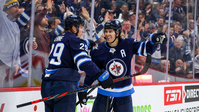 WINNIPEG, MB - OCTOBER 10: Patrik Laine #29 and Mark Scheifele #55 of the Winnipeg Jets celebrate a second period goal against the Minnesota Wild at the Bell MTS Place on October 10, 2019 in Winnipeg, Manitoba, Canada. The Jets defeated the Wild 5-2.