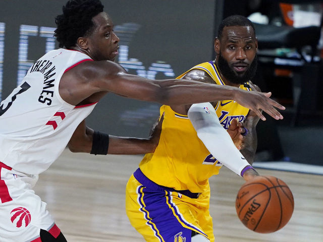 LAKE BUENA VISTA, FLORIDA - AUGUST 01: LeBron James #23 of the Los Angeles Lakers passes the ball against OG Anunoby #3 of the Toronto Raptors during the second half of an NBA basketball game at The Arena in the ESPN Wide World Of Sports Complex on August 1, 2020 in Lake Buena Vista, Florida.
