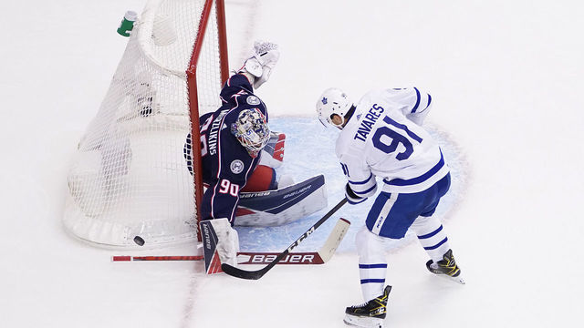 TORONTO, ONTARIO - AUGUST 06: John Tavares #91 of the Toronto Maple Leafs attempts a shot on Elvis Merzlikins #90 of the Columbus Blue Jackets during the second period in Game Three of the Eastern Conference Qualification Round prior to the 2020 NHL Stanley Cup Playoffs at Scotiabank Arena on August 06, 2020 in Toronto, Ontario.