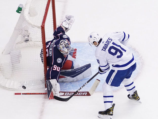 TORONTO, ONTARIO - AUGUST 06: John Tavares #91 of the Toronto Maple Leafs attempts a shot on Elvis Merzlikins #90 of the Columbus Blue Jackets during the second period in Game Three of the Eastern Conference Qualification Round prior to the 2020 NHL Stanley Cup Playoffs at Scotiabank Arena on August 06, 2020 in Toronto, Ontario.
