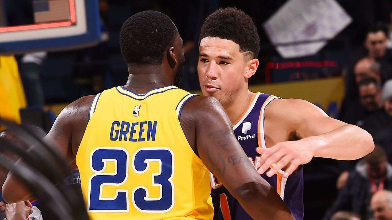 OAKLAND, CA - MARCH 10: Draymond Green #23 of the Golden State Warriors and Devin Booker #1 of the Phoenix Suns hug after the game between the two teams on March 10, 2019 at ORACLE Arena in Oakland, California. NOTE TO USER: User expressly acknowledges and agrees that, by downloading and or using this photograph, user is consenting to the terms and conditions of Getty Images License Agreement. Mandatory Copyright Notice: Copyright 2019 NBAE