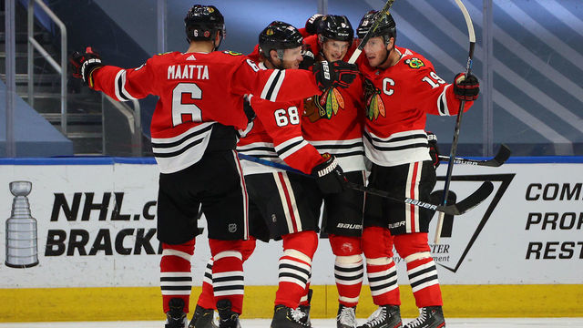 EDMONTON, ALBERTA - AUGUST 07: Dominik Kubalik #8 of the Chicago Blackhawks celebrates with teammates Slater Koekkoek #68, Jonathan Toews #19 and Olli Maatta #6 after Kubalik scored a goal in the third period of Game Four of the Western Conference Qualification Round against the Edmonton Oilers at Rogers Place on August 07, 2020 in Edmonton, Alberta.