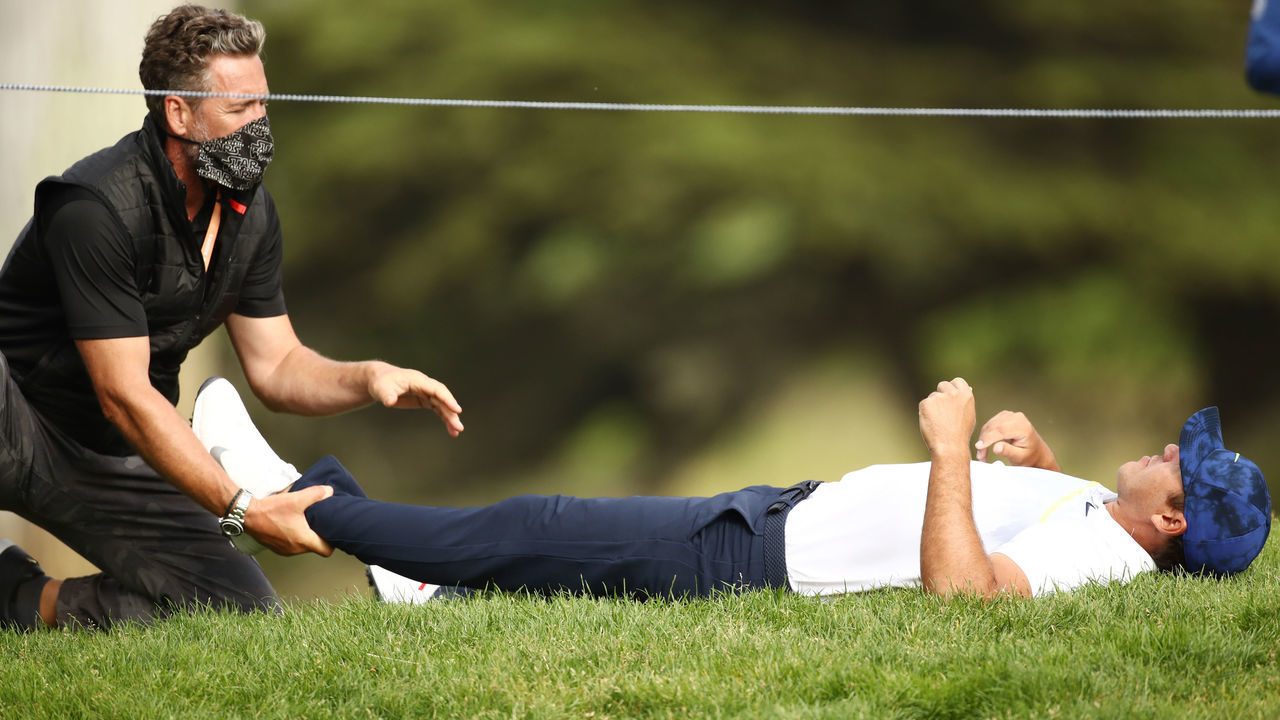 SAN FRANCISCO, CALIFORNIA - AUGUST 07: Brooks Koepka of the United States stretches out on the 12th hole during the second round of the 2020 PGA Championship at TPC Harding Park on August 07, 2020 in San Francisco, California.