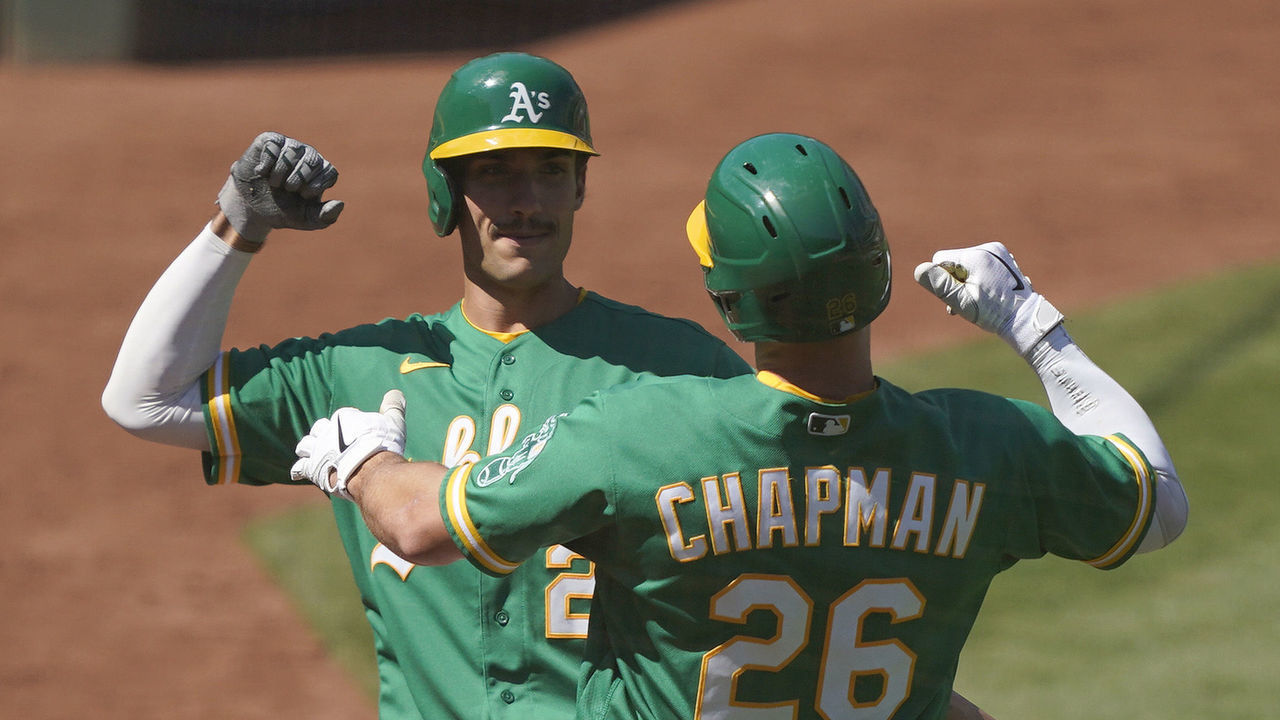 OAKLAND, CALIFORNIA - AUGUST 08: Matt Chapman #26 and Matt Olson #28 of the Oakland Athletics celebrate after Chapman hit a solo home run against the Houston Astros in the bottom of the eighth inning at RingCentral Coliseum on August 08, 2020 in Oakland, California.